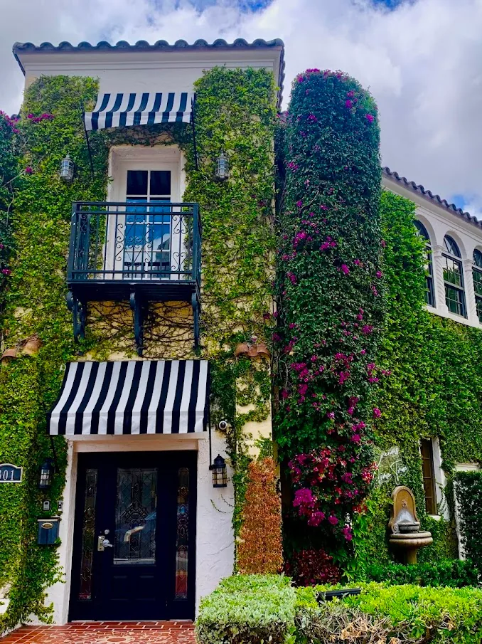 La Jolla's ivy-covered tower with magenta bougainvillea, a balcony and a striped awning.