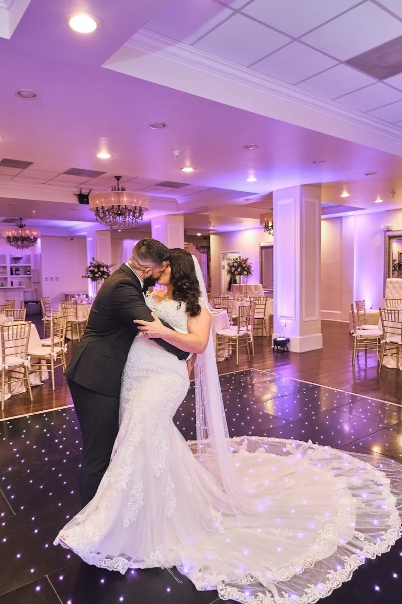 A bride and groom embrace on a starlit dance floor inside La Jolla.